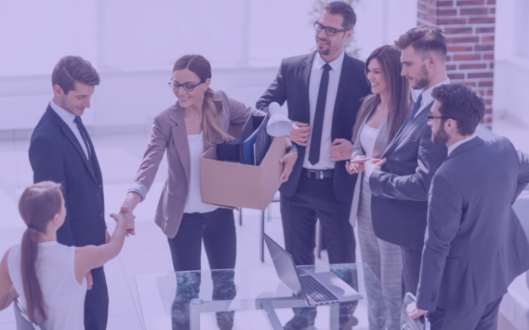 A group of office workers welcoming a new female employee.