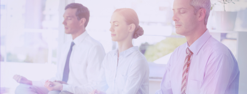 Employees sitting on the floor doing yoga.